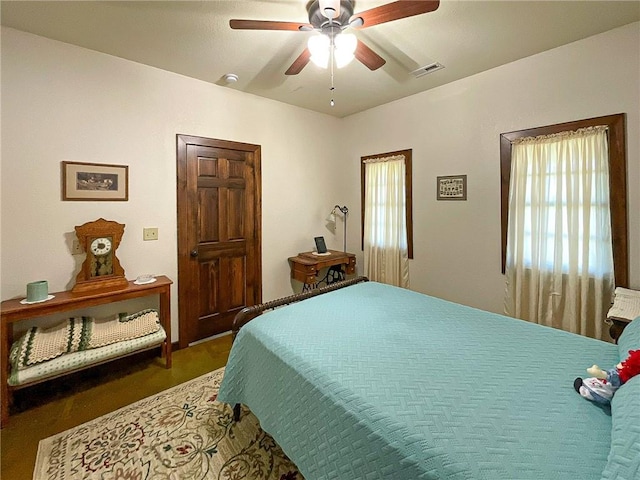 bedroom featuring multiple windows and ceiling fan