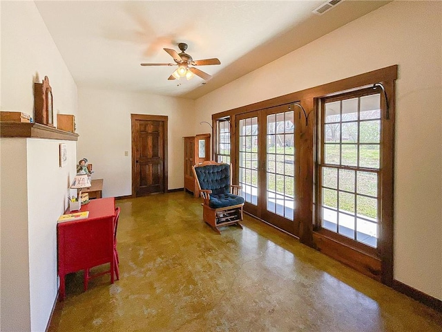 sitting room with ceiling fan and french doors