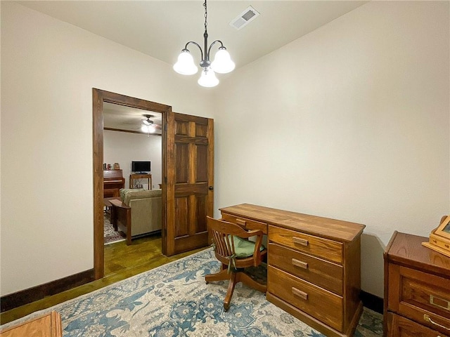 office area featuring ceiling fan with notable chandelier