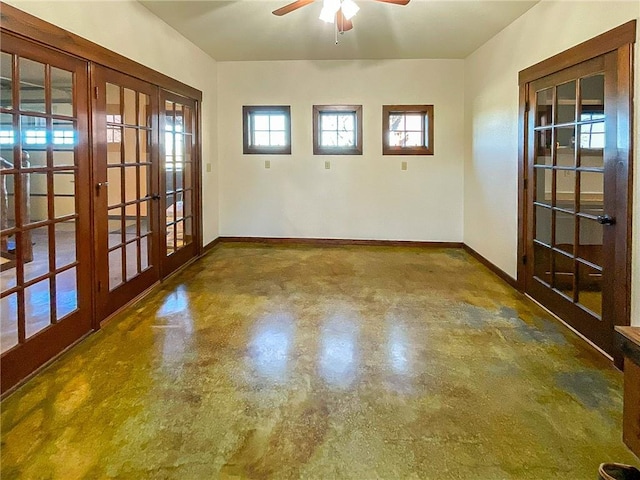 empty room with ceiling fan, a healthy amount of sunlight, and french doors