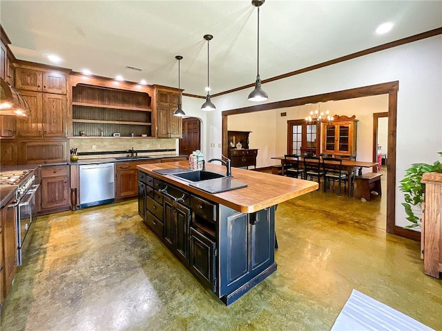 kitchen with sink, wooden counters, decorative backsplash, a center island with sink, and appliances with stainless steel finishes