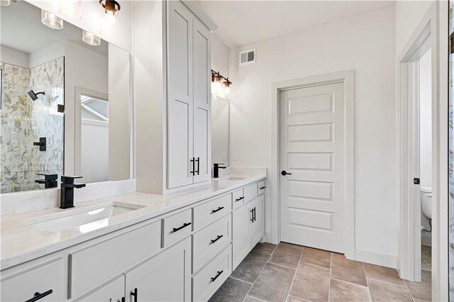 14500 Meadow Ln, Leawood, KS 66224 - bathroom featuring a sink, visible vents, a shower stall, and double vanity