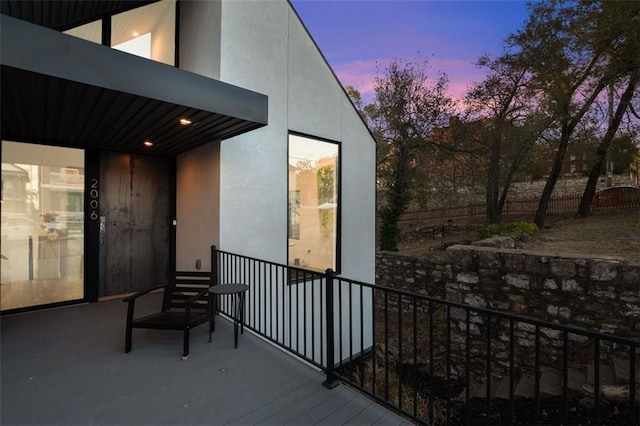 view of balcony at dusk