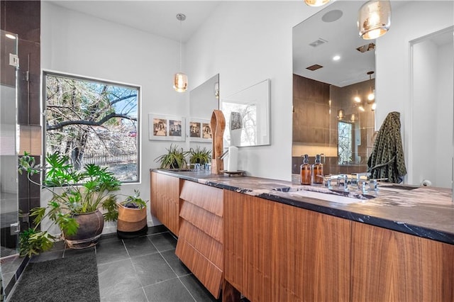 bathroom with tile flooring and double sink vanity