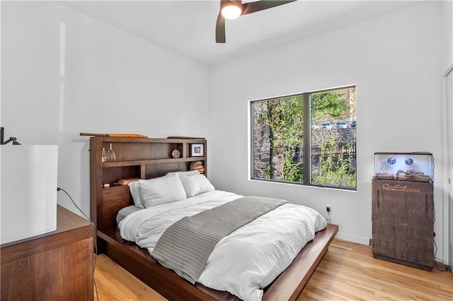 bedroom with ceiling fan and light wood-type flooring