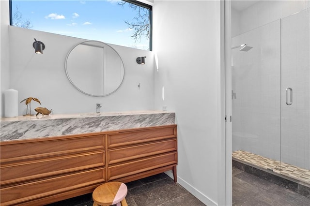 bathroom with plenty of natural light, tile flooring, a shower with shower door, and large vanity