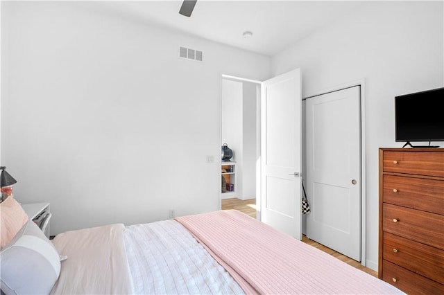 bedroom with a closet, ceiling fan, and light hardwood / wood-style flooring