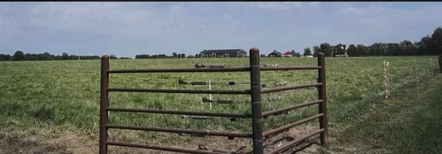 view of gate with a rural view