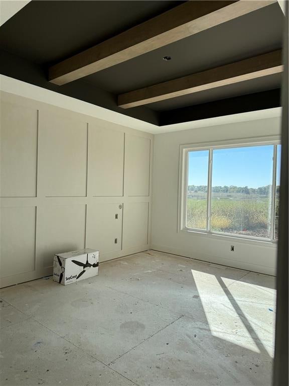 spare room featuring beamed ceiling