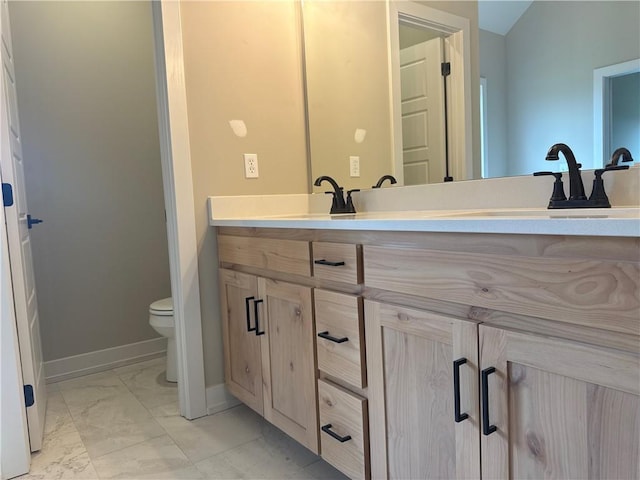 bathroom with vanity and toilet