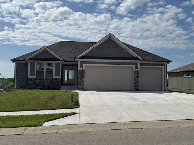12915 N Champanel Way, Platte City, MO 64079 - craftsman inspired home featuring a garage, a front yard, driveway, stone siding, and roof with shingles