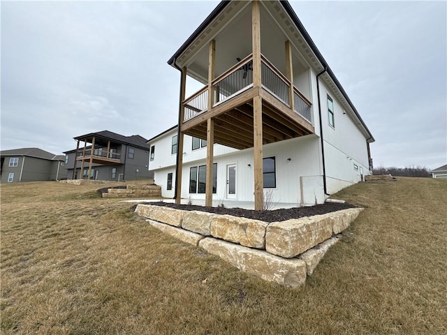 back of property featuring a yard and a balcony