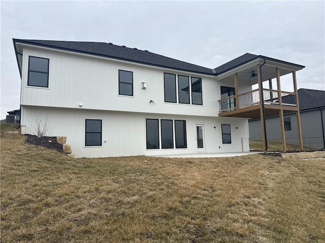 back of property featuring ceiling fan, a yard, and a patio