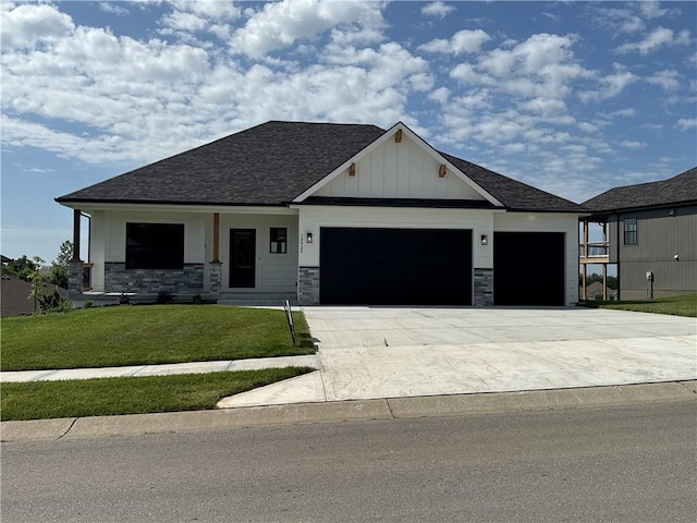 12925 N Champanel Way, Platte City, MO 64079 - view of front of property featuring an attached garage, a front yard, roof with shingles, concrete driveway, and board and batten siding