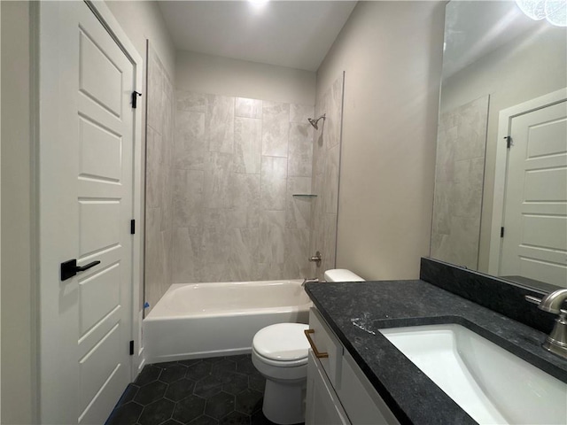 full bathroom with vanity, tiled shower / bath combo, tile patterned floors, and toilet