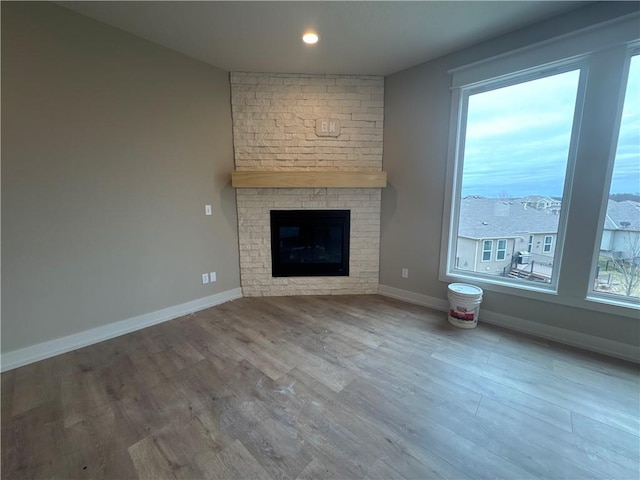 unfurnished living room with hardwood / wood-style flooring and a fireplace