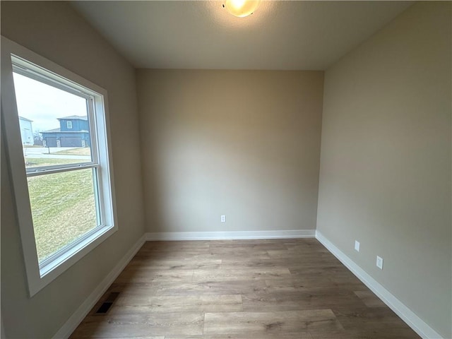 spare room with a healthy amount of sunlight and light wood-type flooring