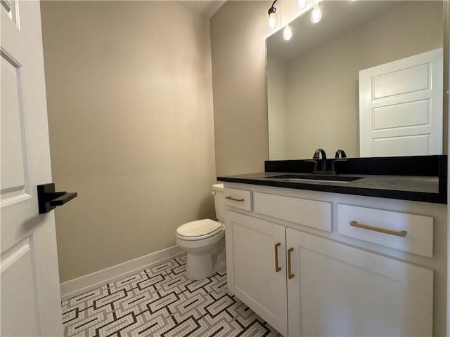 bathroom with vanity, tile patterned flooring, and toilet