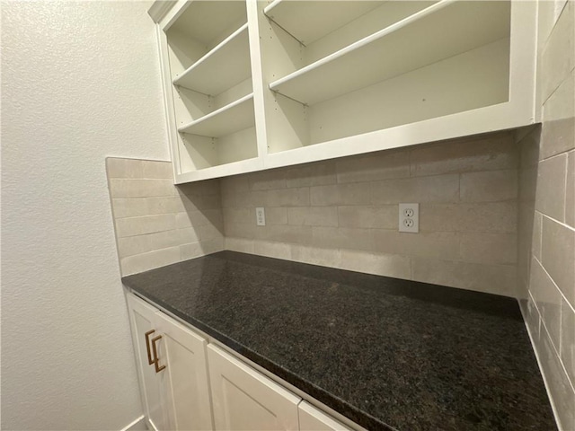 kitchen featuring decorative backsplash and white cabinets