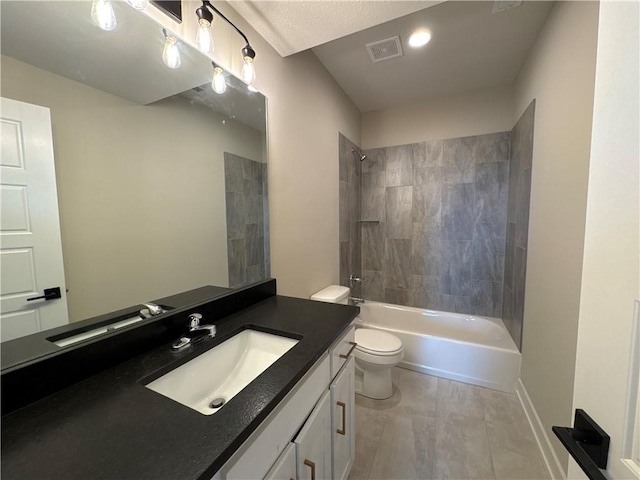 full bathroom featuring tiled shower / bath combo, vanity, and toilet