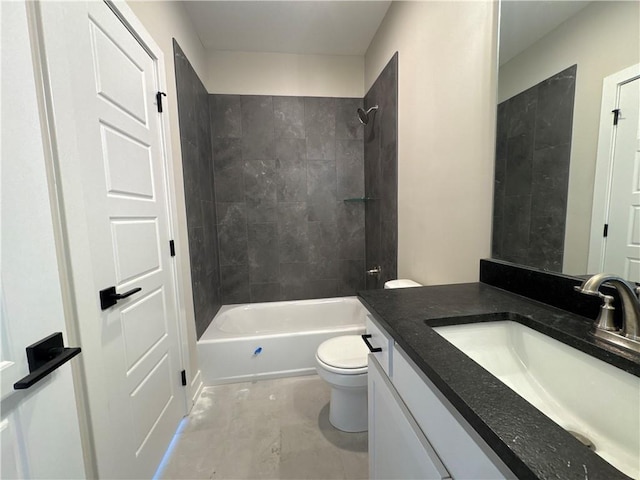 full bathroom with tiled shower / bath, vanity, and toilet