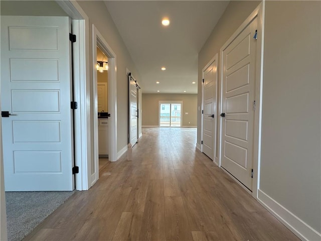 corridor with light hardwood / wood-style flooring