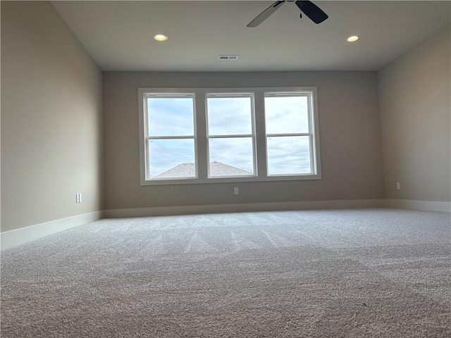 carpeted spare room with ceiling fan and a healthy amount of sunlight