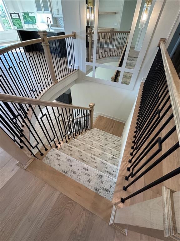 stairway with hardwood / wood-style floors