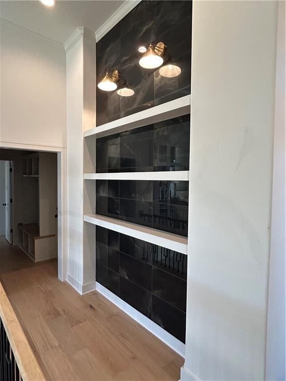 interior details featuring hardwood / wood-style floors and crown molding