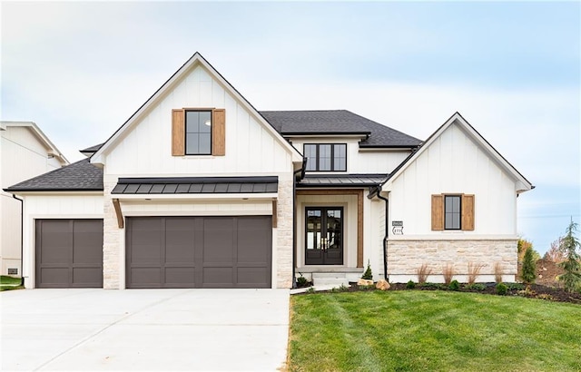 modern farmhouse featuring a garage and a front lawn