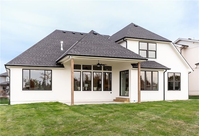 back of property featuring ceiling fan and a lawn