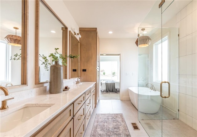 bathroom featuring vanity, a tub, and tile patterned floors