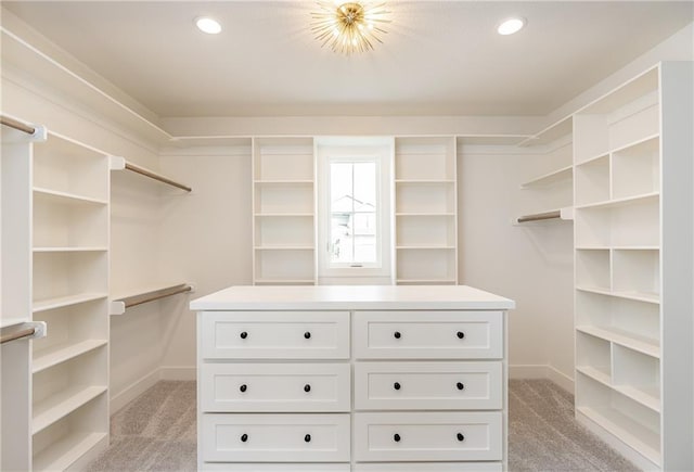 walk in closet with light colored carpet