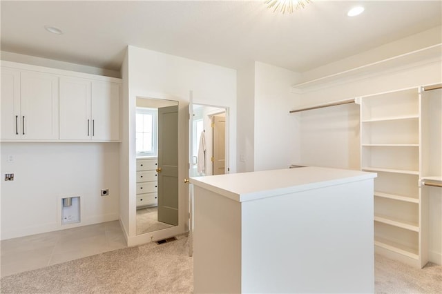 spacious closet with light colored carpet