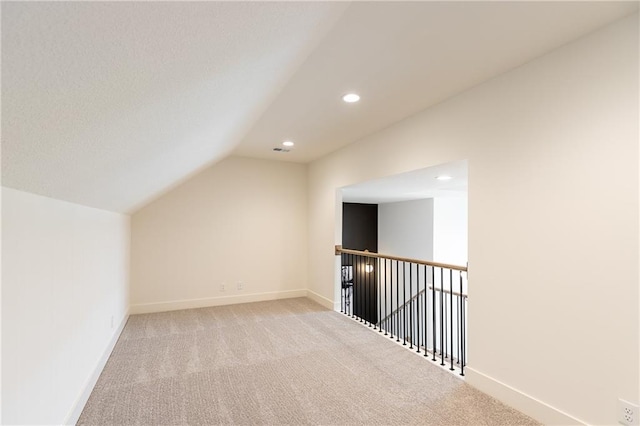 additional living space with lofted ceiling and light colored carpet