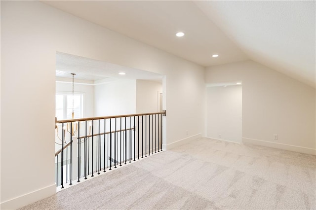 additional living space with vaulted ceiling and light colored carpet