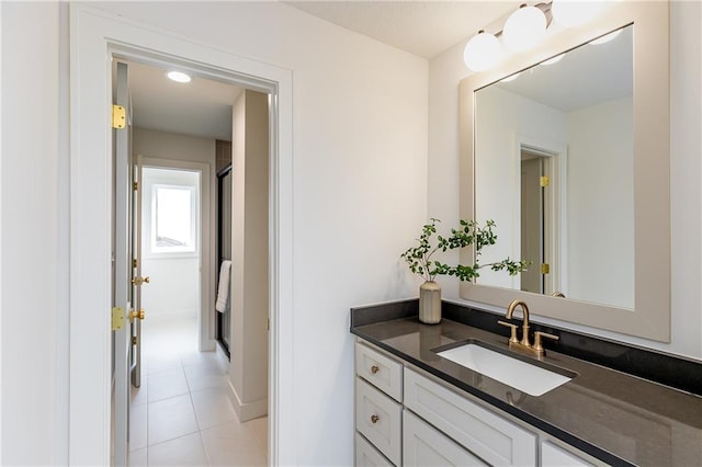 bathroom with vanity, tile patterned floors, and walk in shower