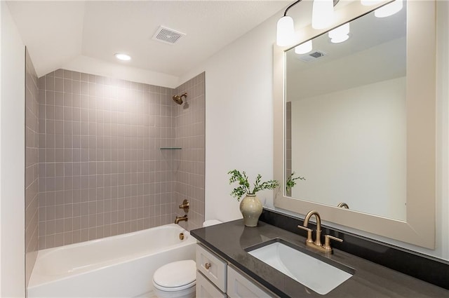 full bathroom featuring vanity, toilet, and tiled shower / bath combo