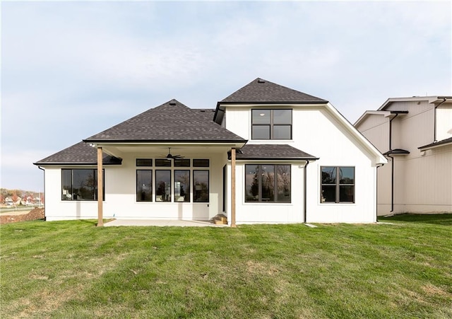 rear view of property with a yard and ceiling fan