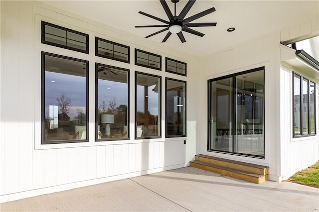 entrance to property with a patio area and ceiling fan