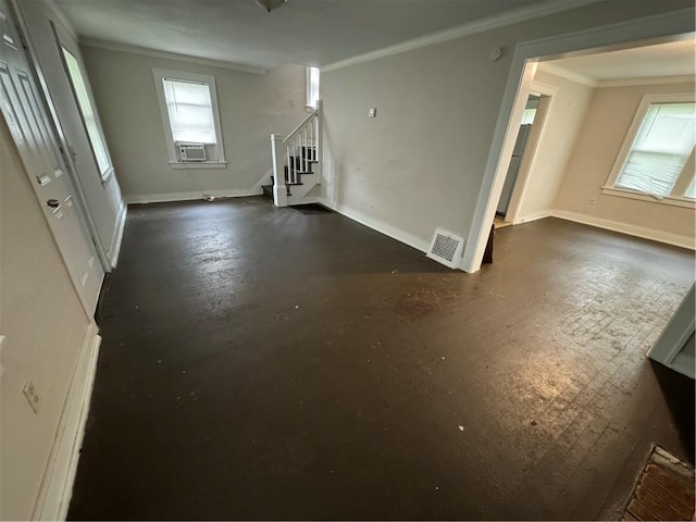 unfurnished living room featuring ornamental molding, a healthy amount of sunlight, and cooling unit