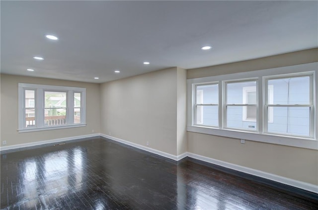 empty room with dark hardwood / wood-style floors