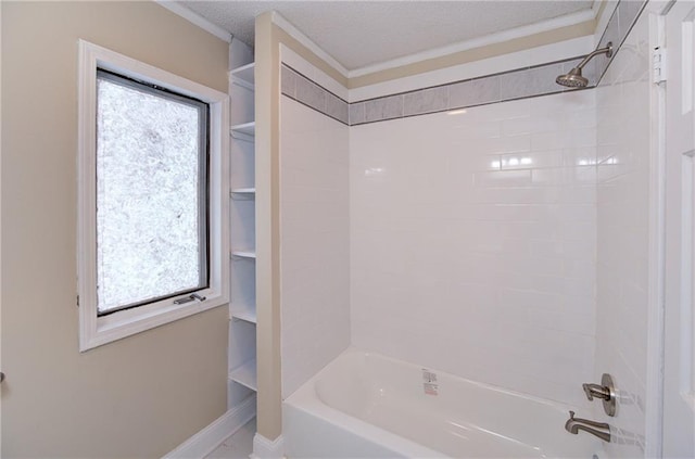 bathroom with tiled shower / bath combo and a textured ceiling