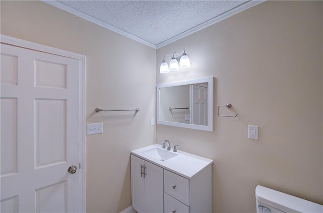 bathroom featuring crown molding, a textured ceiling, toilet, and vanity with extensive cabinet space