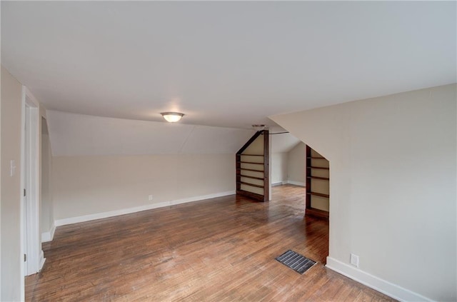 basement featuring dark hardwood / wood-style flooring