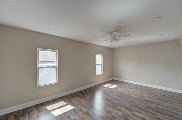 spare room with ceiling fan and dark hardwood / wood-style flooring