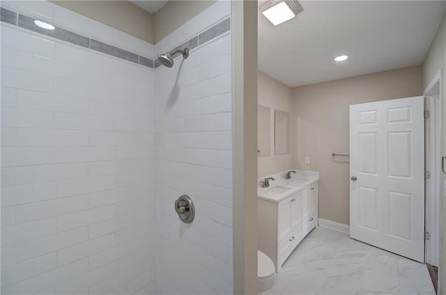 bathroom featuring toilet, tiled shower, tile floors, and large vanity