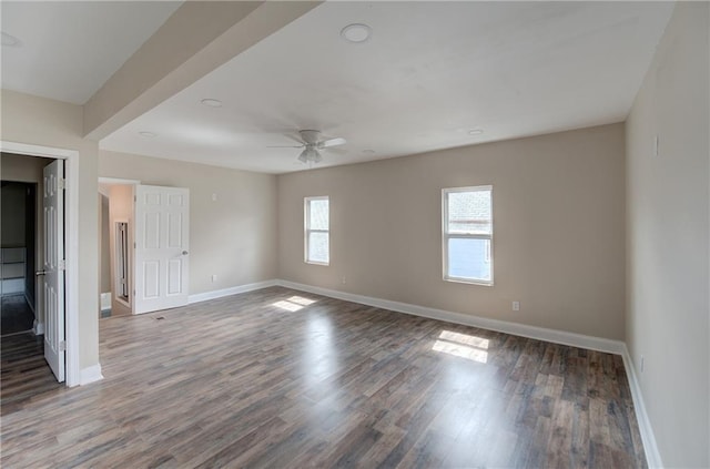 spare room featuring dark hardwood / wood-style flooring and ceiling fan