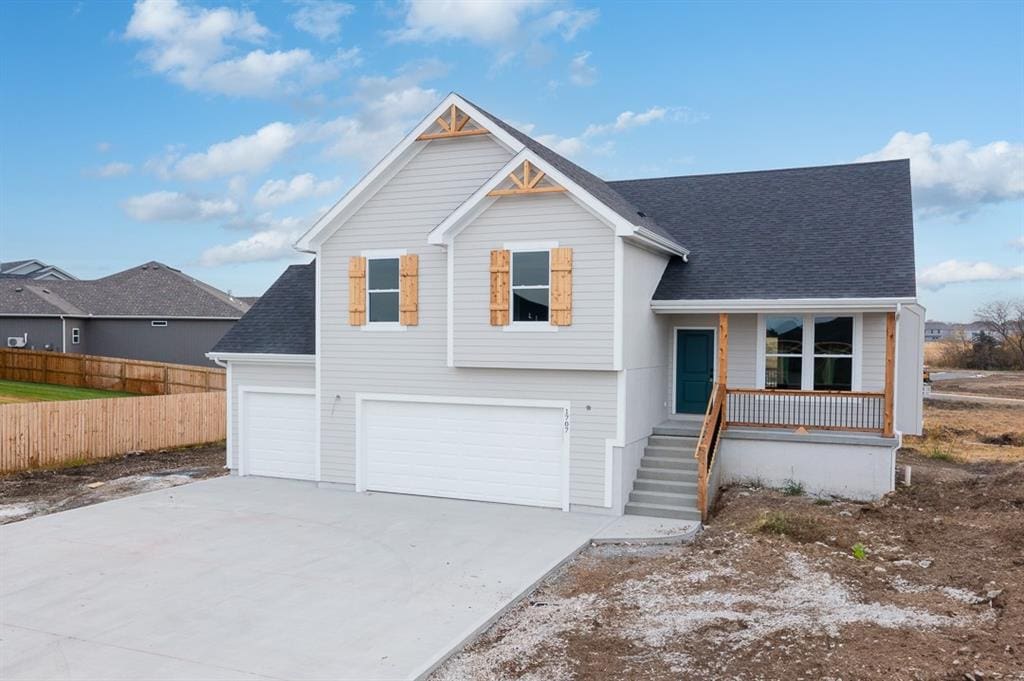 view of front facade with a garage and a porch