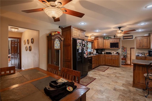 kitchen with sink, kitchen peninsula, ceiling fan, and black appliances